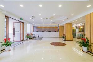 a large lobby with plants in a building at GreenTree Inn Shanghai Jingan Railway Station Xinzha Road Business Hotel in Shanghai