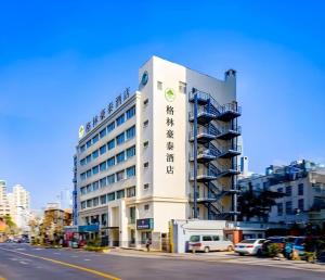 a building with a sign on the side of it at GreenTree Inn Shanghai Jingan Railway Station Xinzha Road Business Hotel in Shanghai