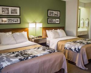 a hotel room with two beds and a lamp at Sleep Inn in Geistown +51 photos