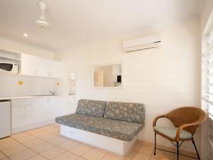 a living room with a couch and a chair at Tropic Haven in Airlie Beach