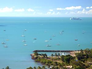 a group of boats in the water on a beach at Tropic Haven in Airlie Beach