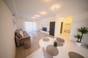 ein Wohnzimmer mit Sofa und Tisch in der Unterkunft Malvina Apartments Cazare Mures in Târgu Mureș