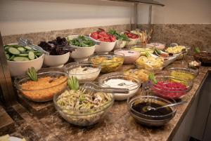 a bunch of bowls of food on a counter at Hilly Hotel in Edirne +41 photos