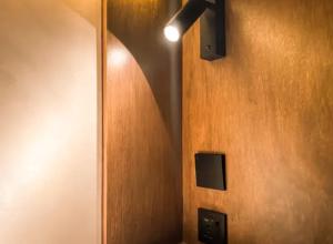 a room with a wooden wall with a light on it at Yamato Hostel in Manila