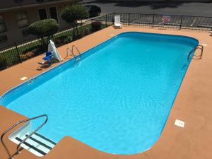 a large blue swimming pool in a building at Americas Best Value Inn - Malvern in Malvern