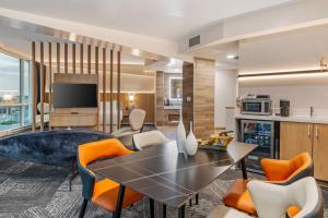 a living room with a table and chairs at Clarion Lakeside Inn & Conference Centre in Kenora