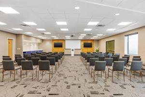 a conference room with chairs and a whiteboard at Clarion Lakeside Inn & Conference Centre in Kenora