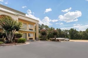 a parking lot in front of a building at Quality Inn McComb in McComb