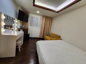 Ένα ή περισσότερα κρεβάτια σε δωμάτιο στο CK Inn