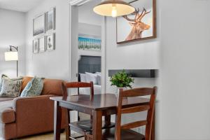 a living room with a table and a couch at Heavenly Hideaway Ski-In-Out Pool Shuttle in Blue Mountains