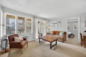 a living room with a couch and a table at Heavenly Hideaway Ski-In-Out Pool Shuttle in Blue Mountains