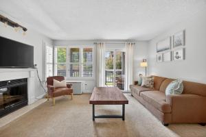 a living room with a couch and a table at Heavenly Hideaway Ski-In-Out Pool Shuttle in Blue Mountains