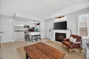 a living room with a fireplace and a table and chairs at Heavenly Hideaway Ski-In-Out Pool Shuttle in Blue Mountains +52 photos