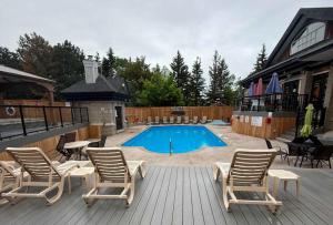 a patio with chairs and a swimming pool at Heavenly Hideaway Ski-In-Out Pool Shuttle in Blue Mountains