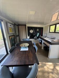 a dining room with a table and chairs and a desk at Thornbird Lodge in Robertson