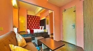 a living room with a couch and a table at OYO 90484 Bright Hotel in Sungai Way