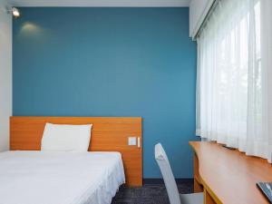 a blue bedroom with a bed and a blue wall at Comfort Inn Karuizawa in Karuizawa +23 photos