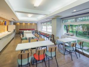 a classroom with tables and chairs in a cafeteria at Comfort Inn Karuizawa in Karuizawa