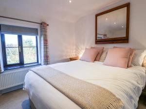 En eller flere senge i et værelse på Pine Cottage