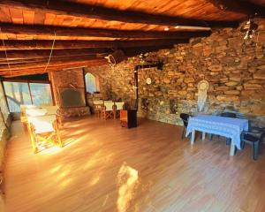 a living room with a table and a stone wall at Kybele Nature Life in Edremit +57 photos