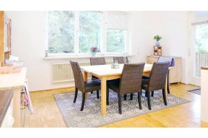 a dining room with a wooden table and chairs at White Villa in Baden