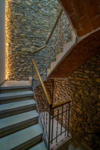 a staircase in a building with a stone wall at Apartaments Cal Xic in Bellver de Cerdanya