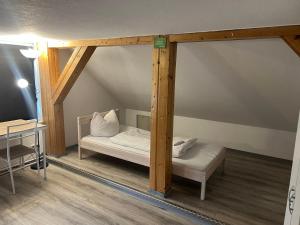 a bed in a room with a wooden frame at Basic Monteurzimmer Work & Stay in Kempten