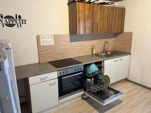 a kitchen with a sink and a dishwasher at Basic Monteurzimmer Work & Stay in Kempten