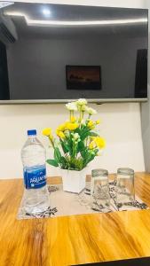 a bottle of water and a vase of flowers on a table at legacy of chittorgarh in Chittaurgarh