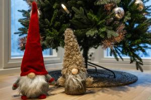 two gnomes standing next to a christmas tree at Villa Lumossa - Lakeside Luxury with unique privacy in Rovaniemi