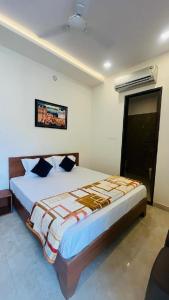 a bedroom with a large bed with blue pillows at legacy of chittorgarh in Chittaurgarh