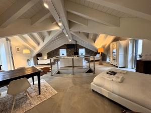 a large room with a bed and a desk in it at Antica Foresteria Karolingia in Ponte di Legno