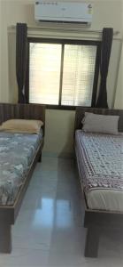 two beds in a room with a window at Calm Studio 6 in Jāmb +11 photos