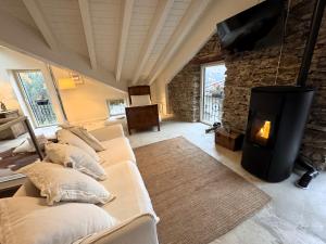 a living room with three couches and a fireplace at Antica Foresteria Karolingia in Ponte di Legno