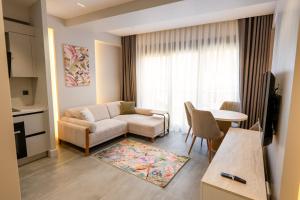 a living room with a couch and a table at Boamonti Residence Sisli Apart in Istanbul