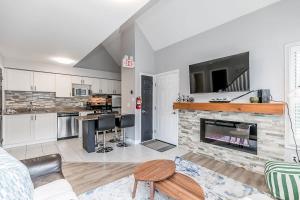 a living room with a fireplace and a tv at Mountain View Ski-In-Out Pool Shuttle to Blue in Blue Mountains