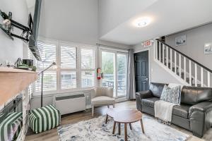 a living room with a couch and a staircase at Mountain View Ski-In-Out Pool Shuttle to Blue in Blue Mountains