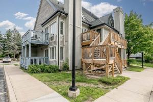 a house with wooden decks on the side of it at Mountain View Ski-In-Out Pool Shuttle to Blue in Blue Mountains