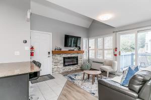 a living room with a couch and a fireplace at Mountain View Ski-In-Out Pool Shuttle to Blue in Blue Mountains