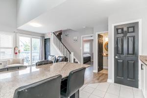 a kitchen and living room with a table and chairs at Mountain View Ski-In-Out Pool Shuttle to Blue in Blue Mountains +33 photos