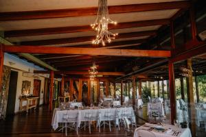 a room with white tables and chairs in it at Forum Homini Boutique Hotel in Krugersdorp