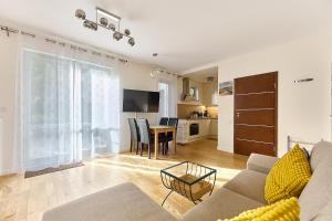 a living room with a couch and a table at Apartamenty Świnoujście - Bałtycka in Świnoujście