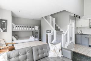 a living room with a bed and a staircase at Northern Tranquility Ski-In-Out Pool Shuttle in Blue Mountains