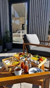 a table with a tray of food on a patio at Na Kameni in Vsetín