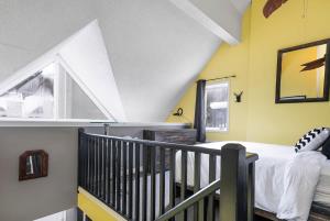 a attic bedroom with a bed and a staircase at Sunshine Summit Ski-In-Out Pool Shuttle in Blue Mountains