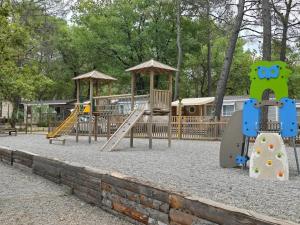 南莱潘Bungalow confortable à Nans-les-Pins de 30 m²的一个带两个秋千和滑梯的游乐场