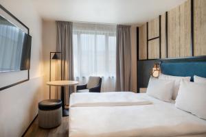 Postel nebo postele na pokoji v ubytování Hotel München City Center affiliated by Meliá