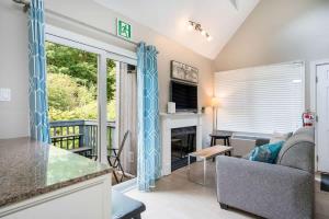 a living room with a couch and a fireplace at Whispering Pines - Ski-In-Ou Pool Shuttle in Blue Mountains