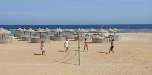 a group of people playing a game on the beach at Oyster Bay Beach Suites in Marsa Alam