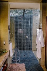a bathroom with a shower with a glass door at Forum Homini Boutique Hotel in Krugersdorp +67 photos